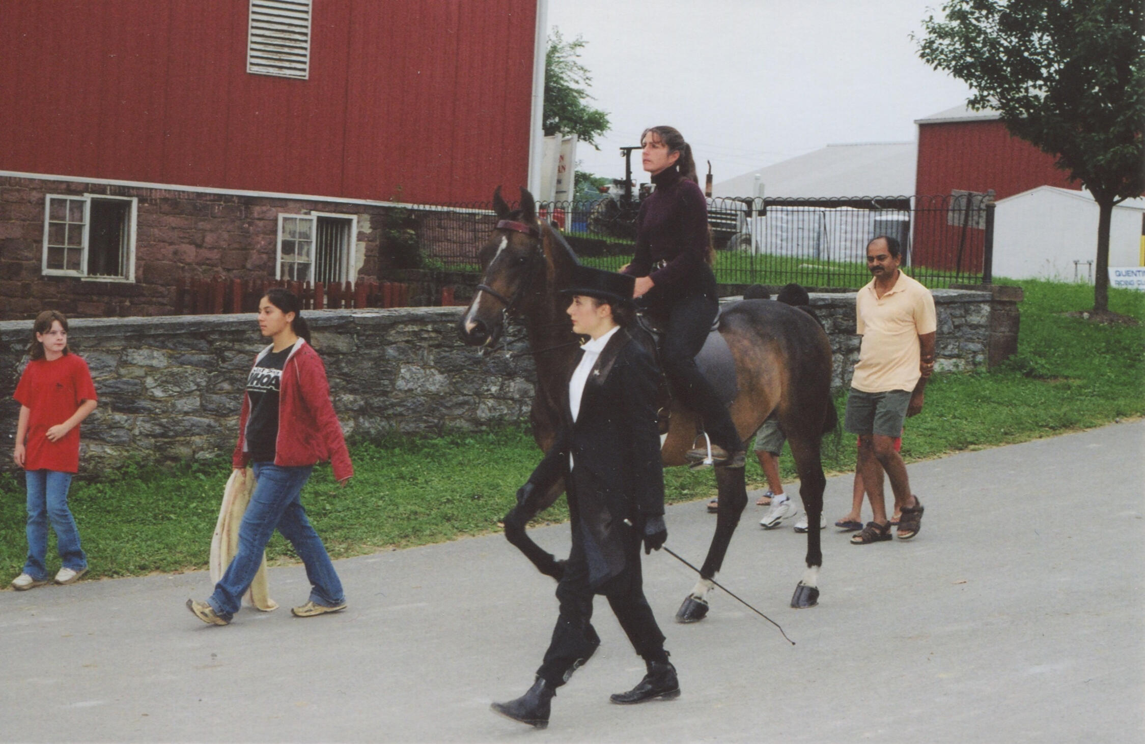 QRC Golden Days Horse show class at Quentin Riding Club during its golden era, with a rider mounted on horseback led past the historic barns